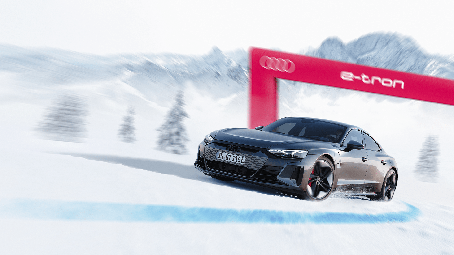A black Audi RS e-tron GT driving on a snow-covered road with the Alps in the background.
