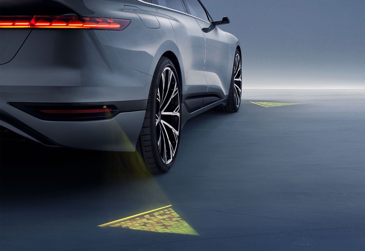 LED projectors on the vehicle create glowing triangles on the ground.