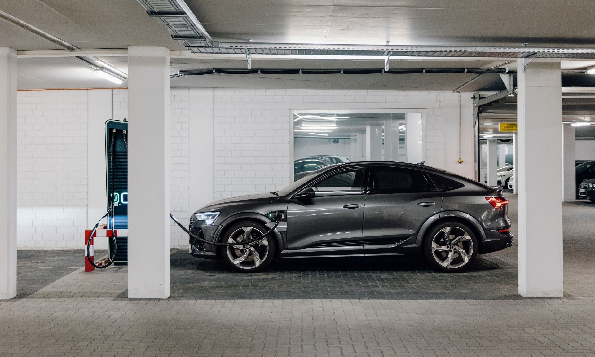 The Audi e-tron S Sportback charges in the underground car park.