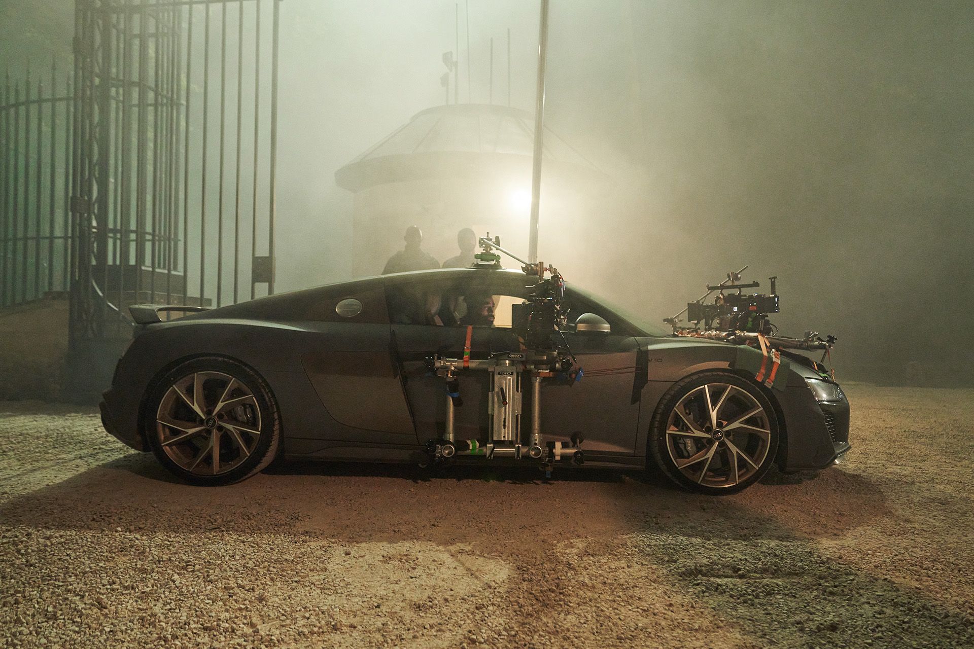 A black Audi R8 V10 can be seen from the side. Various camera systems are mounted on the body.